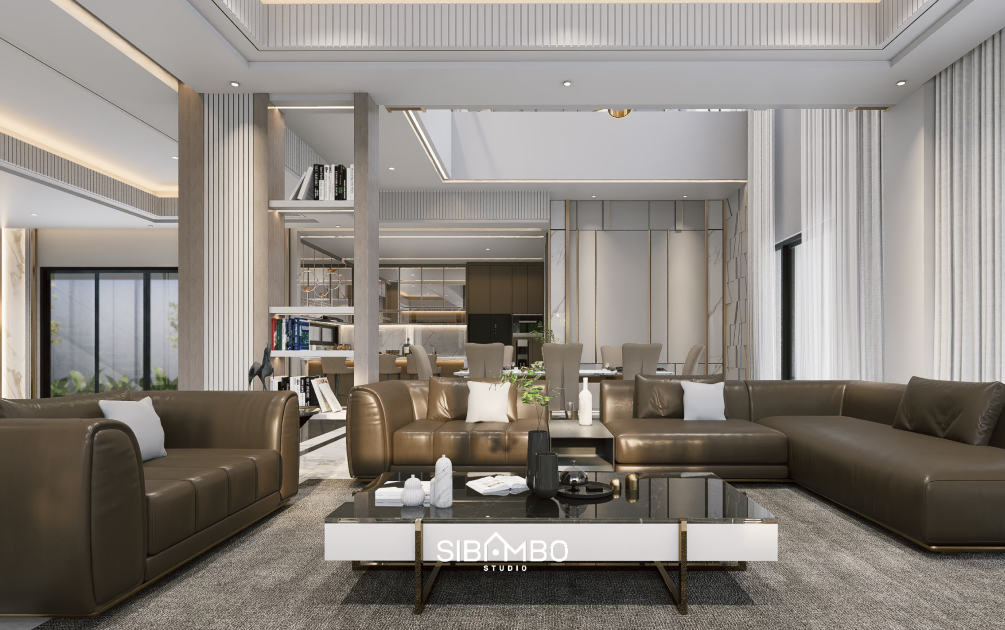 Ruang keluarga Casa Insieme dengan void tinggi dan sofa kulit hasil renovasi interior di Jakarta
