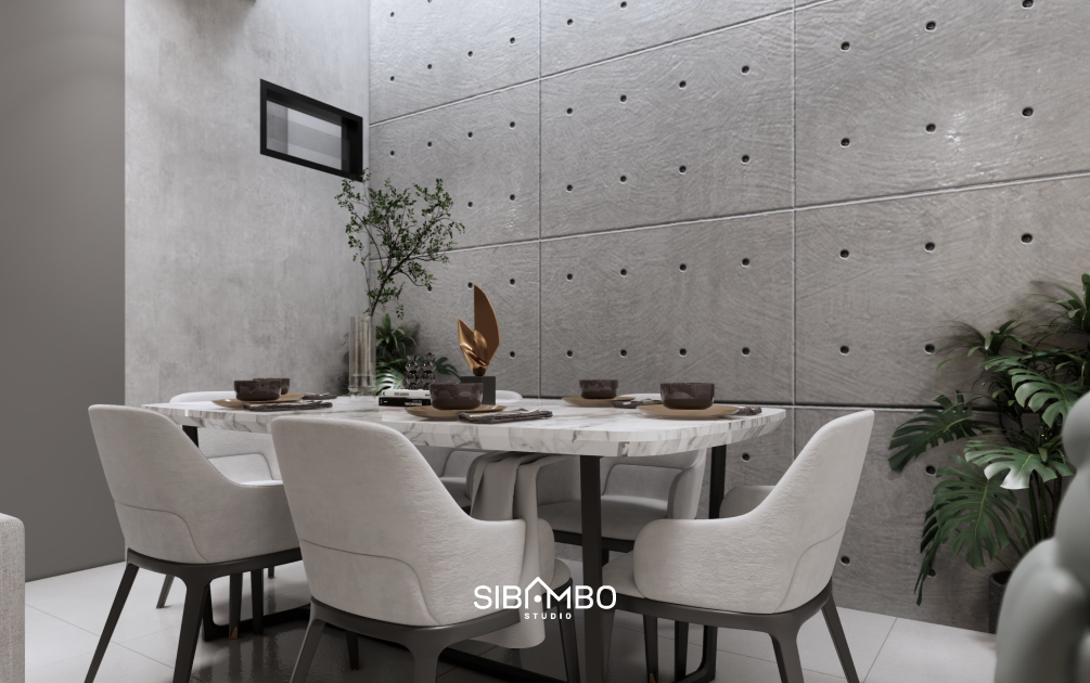 Ruang makan Compact House dengan dinding beton ekspos dan meja marmer bernuansa natural di Jakarta